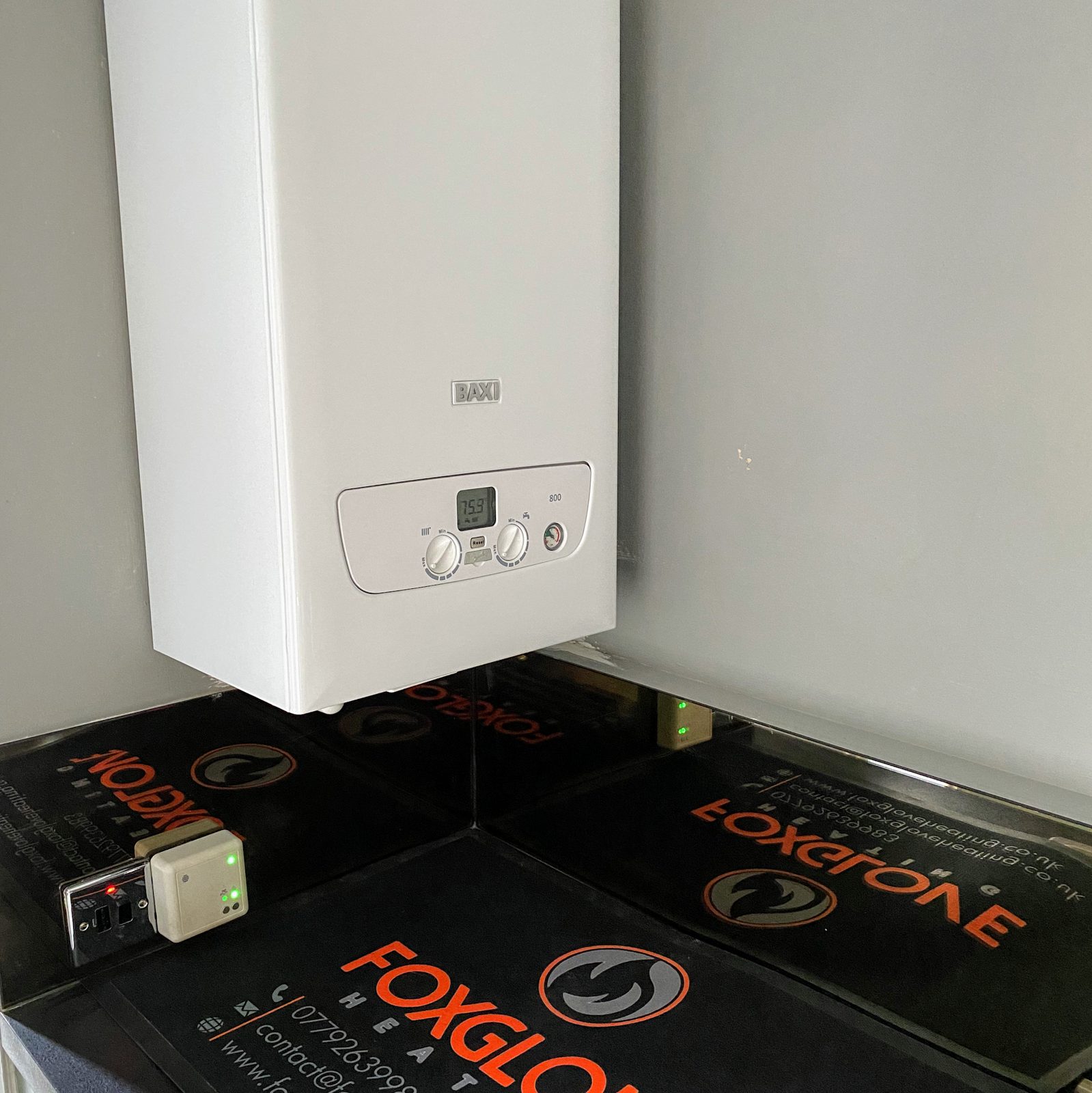 A new white Baxi boiler on a grey wall with a Foxglove Heating mat on the worktop below